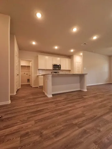 a view of a kitchen with a sink and a refrigerator
