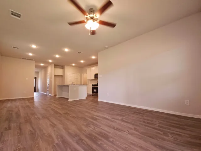a view of kitchen with stove and wooden floor