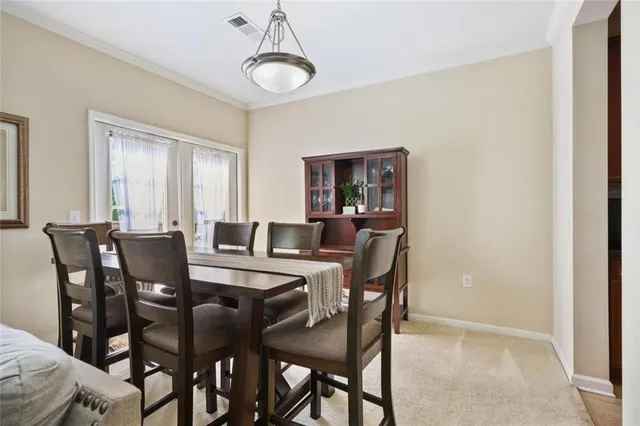 a view of a dining room with furniture and window