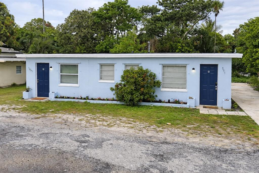 a front view of house with yard and trees