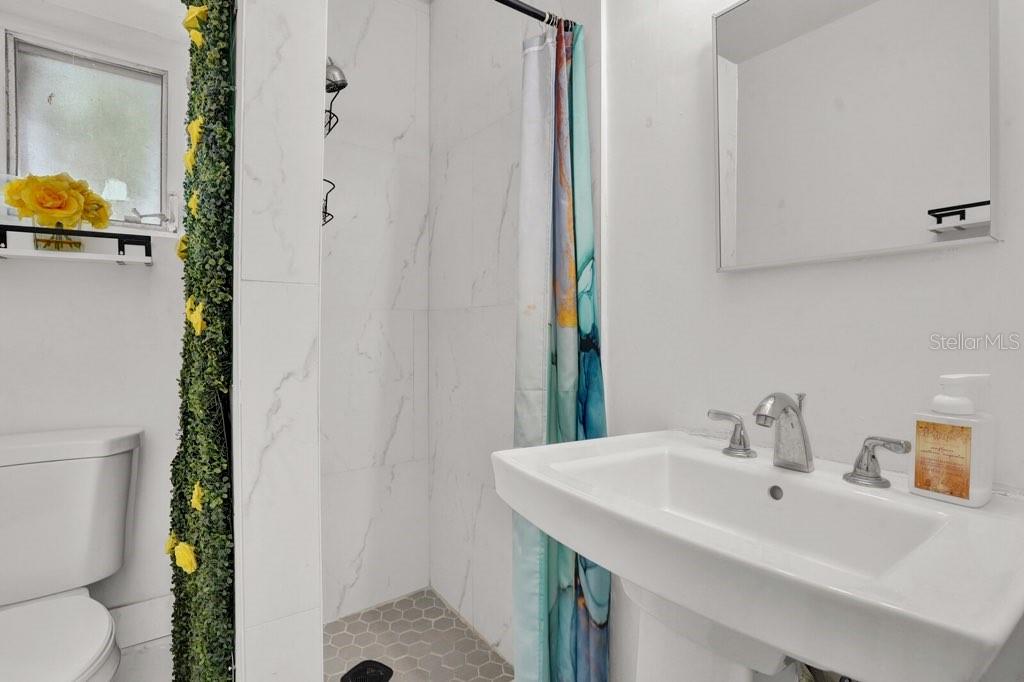 7871 Terrace Road Lantana, FL 33462 - Photo 12 of 19 a bathroom with a sink and a mirror