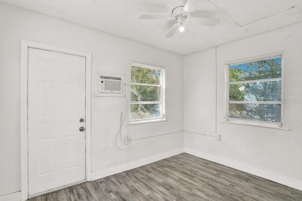 7871 Terrace Road Lantana, FL 33462 - Photo 2 of 19 a view of an empty room with a window and wooden floor