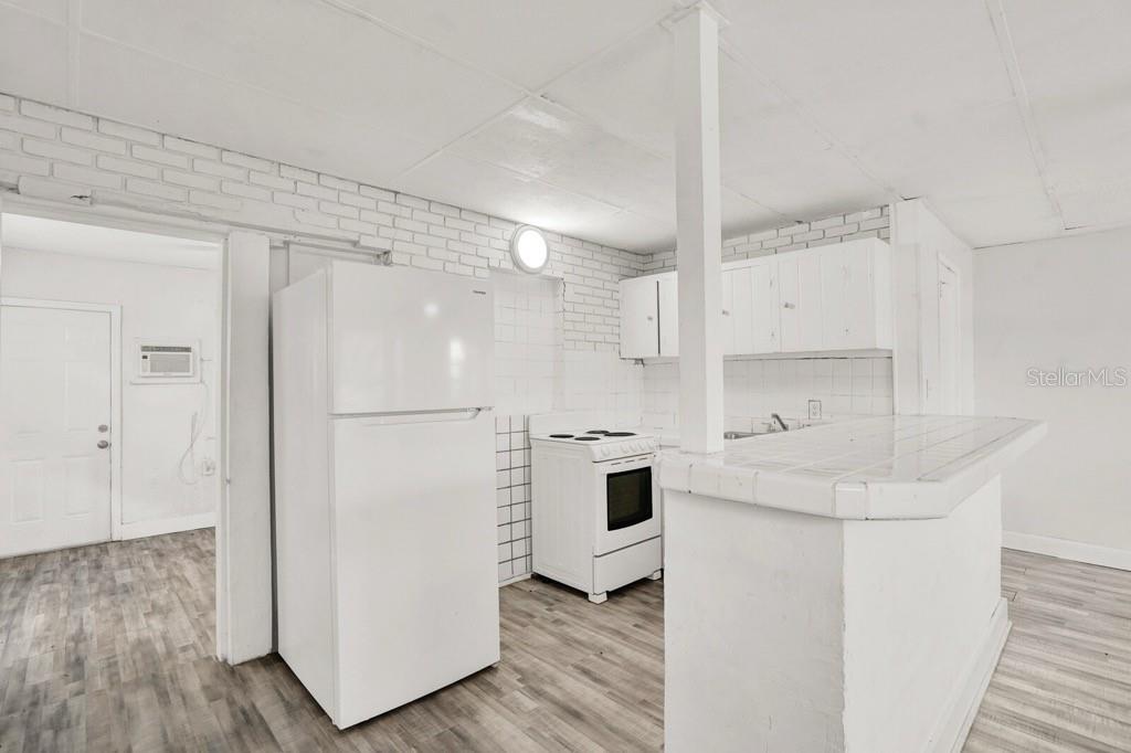 7871 Terrace Road Lantana, FL 33462 - Photo 6 of 19 a kitchen with white cabinets and white appliances