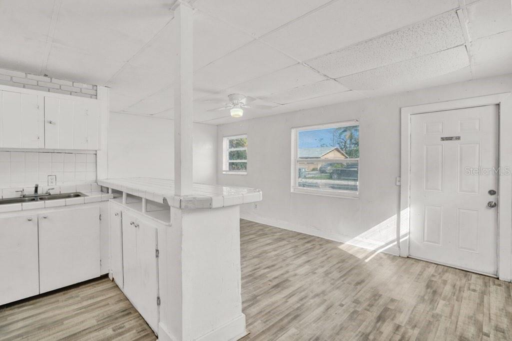 7871 Terrace Road Lantana, FL 33462 - Photo 8 of 19 a view of kitchen with wooden floor electronic appliances and window