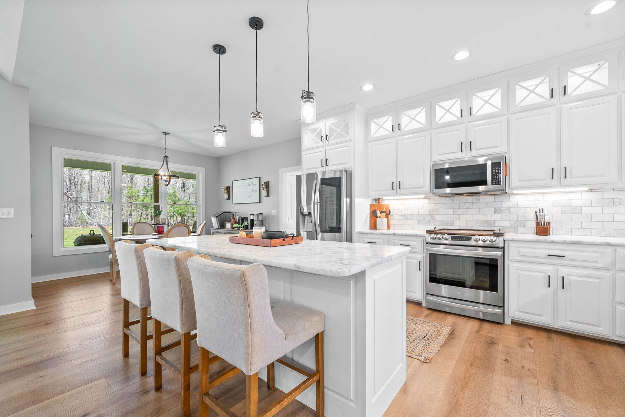 234 Davis Lane Erin, TN 37061 - Photo 15 of 45 a kitchen with stainless steel appliances granite countertop a stove top oven a sink dishwasher a dining table and chairs with wooden floor
