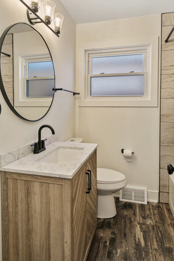 7021 West 64th Street Chicago, IL 60638 - Photo 13 of 23 a bathroom with a sink a toilet and a mirror