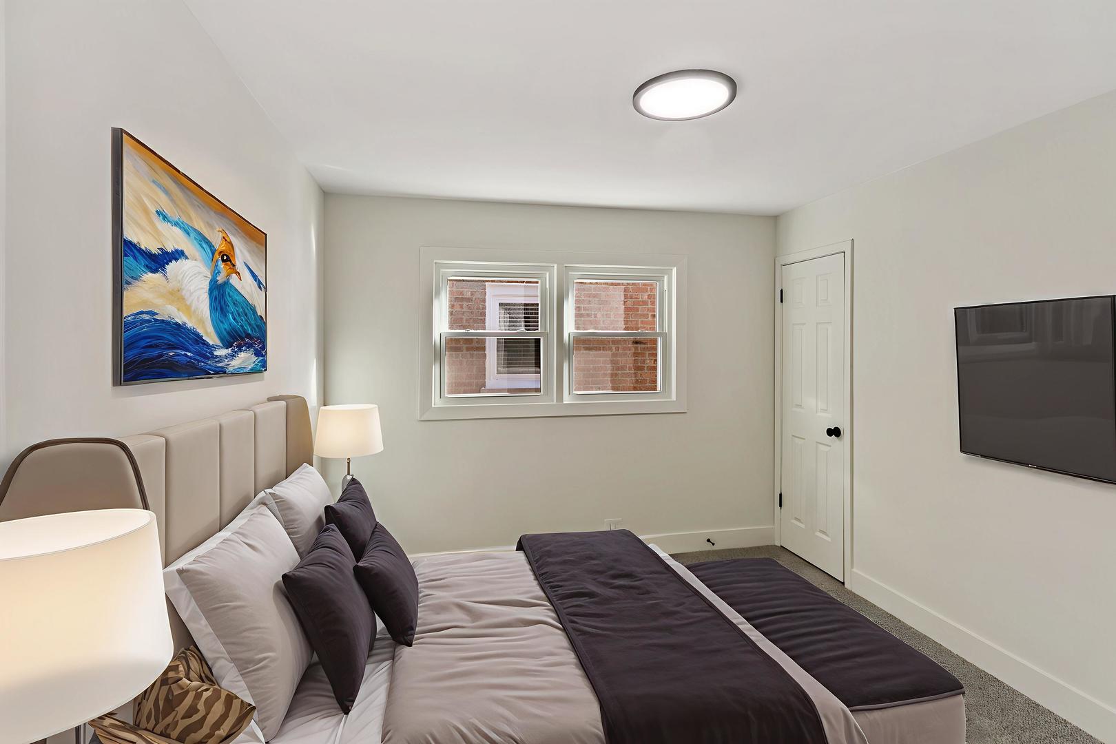 7021 West 64th Street Chicago, IL 60638 - Photo 17 of 23 a bedroom with a bed and a flat screen tv