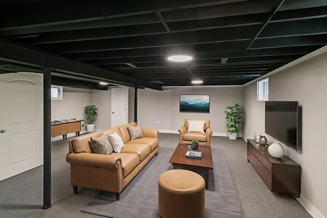 a living room with furniture a rug and a flat screen tv