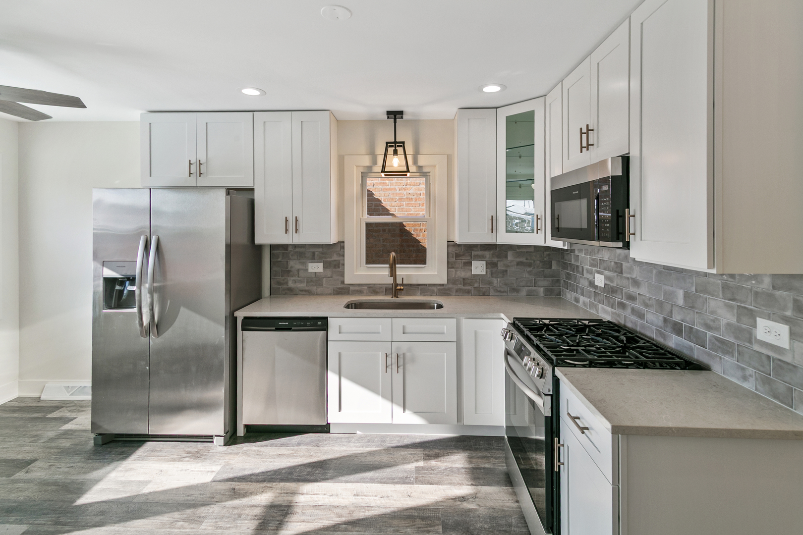 7021 West 64th Street Chicago, IL 60638 - Photo 5 of 23 a kitchen with stainless steel appliances granite countertop a stove refrigerator sink and microwave