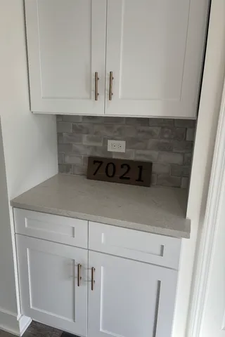 a kitchen with white cabinets and white appliances