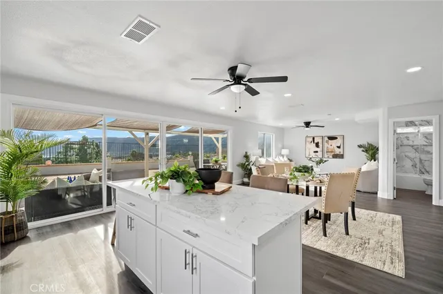 a kitchen with a white stove top oven and white cabinets