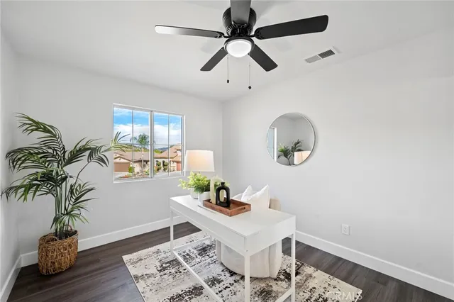 a bedroom with bed and a potted plant