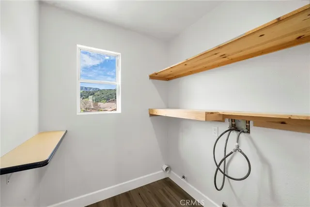 a bathroom with a granite countertop sink and a potted plant