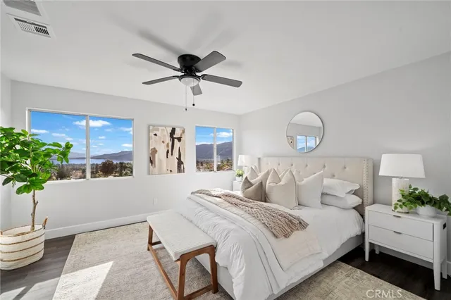 a bedroom with a bed and a potted plant