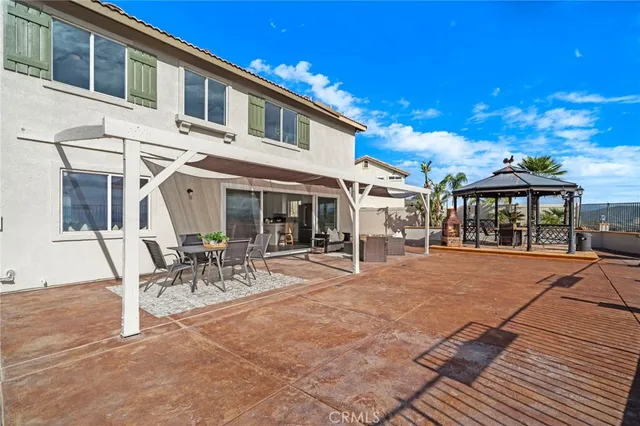 a view of a house with pool and sitting area