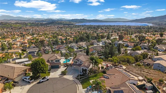 an aerial view of residential houses with outdoor space and trees