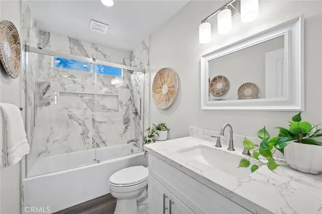 a bathroom with a sink a toilet and a bathtub