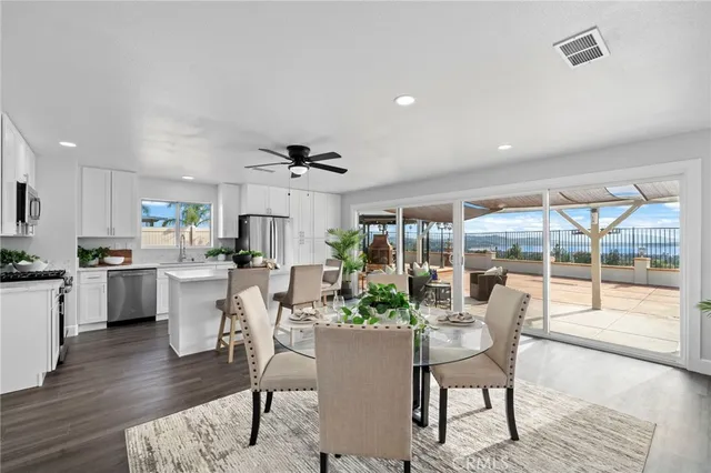 a room with dining table wooden floor and a large window