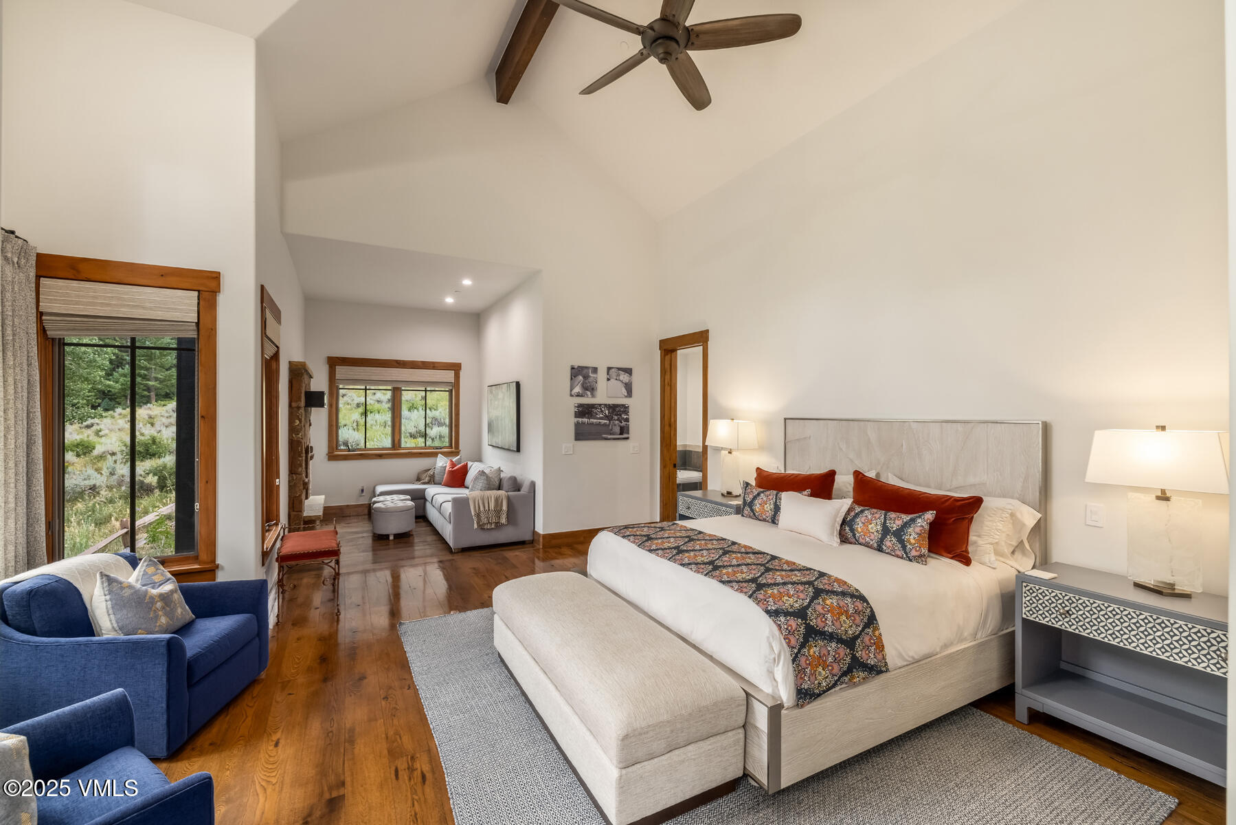 254 Pine Marten Way Edwards, CO 81632 - Photo 27 of 46 a spacious bedroom with a bed a couch and a large window