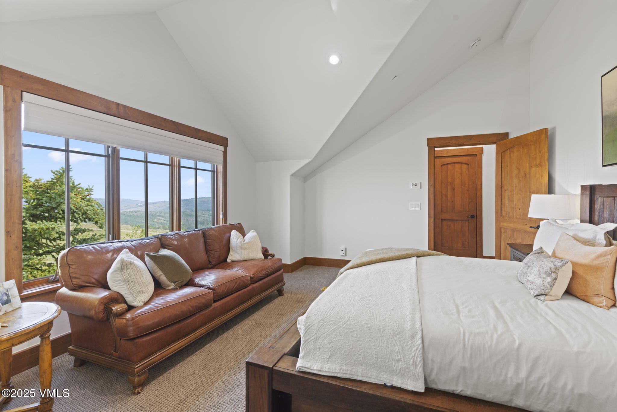 254 Pine Marten Way Edwards, CO 81632 - Photo 33 of 46 a bedroom with a bed couch and a large window
