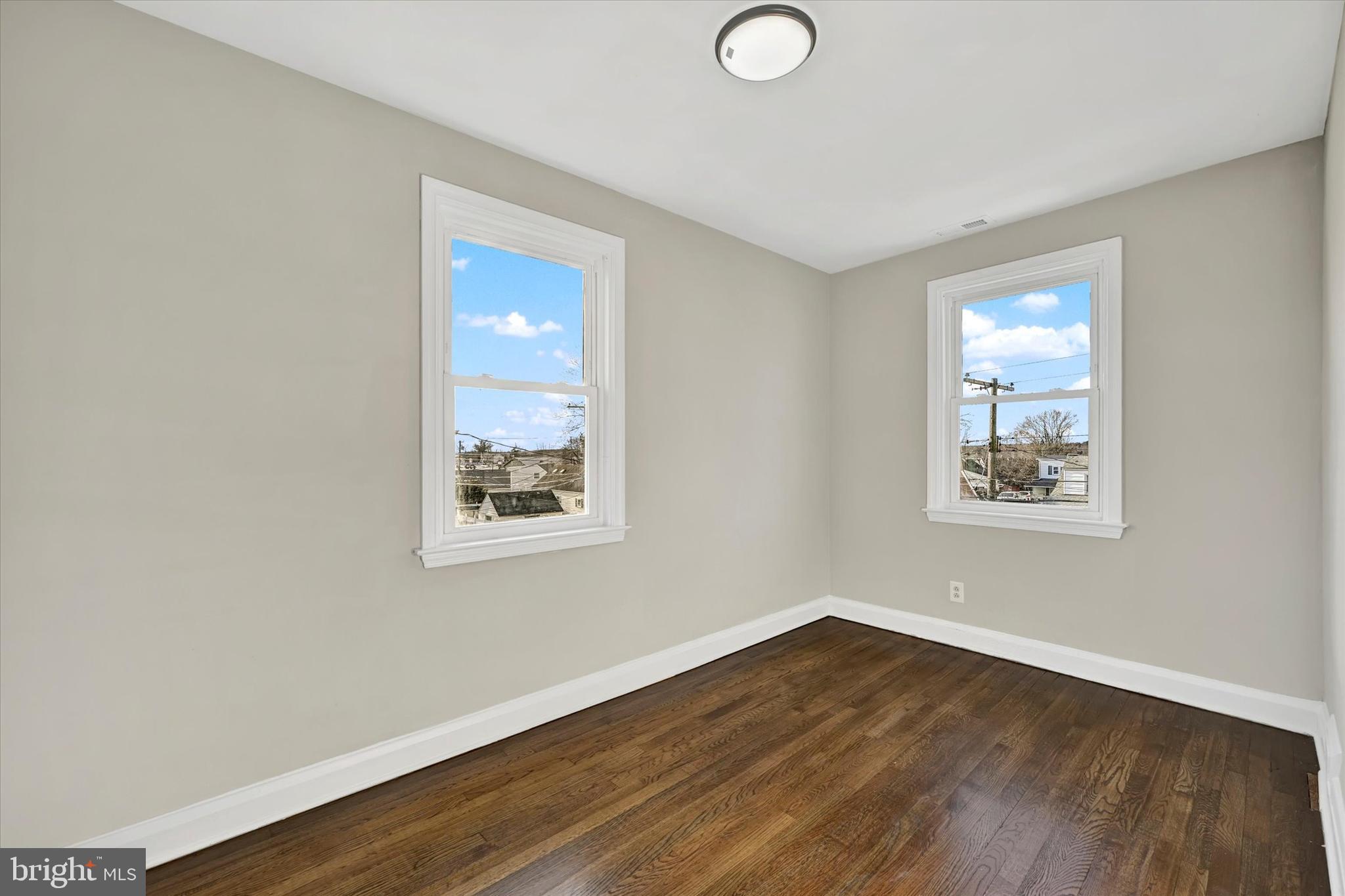 54 Wiltshire Road Essex, MD 21221 - Photo 12 of 22 a view of a room with wooden floor and window