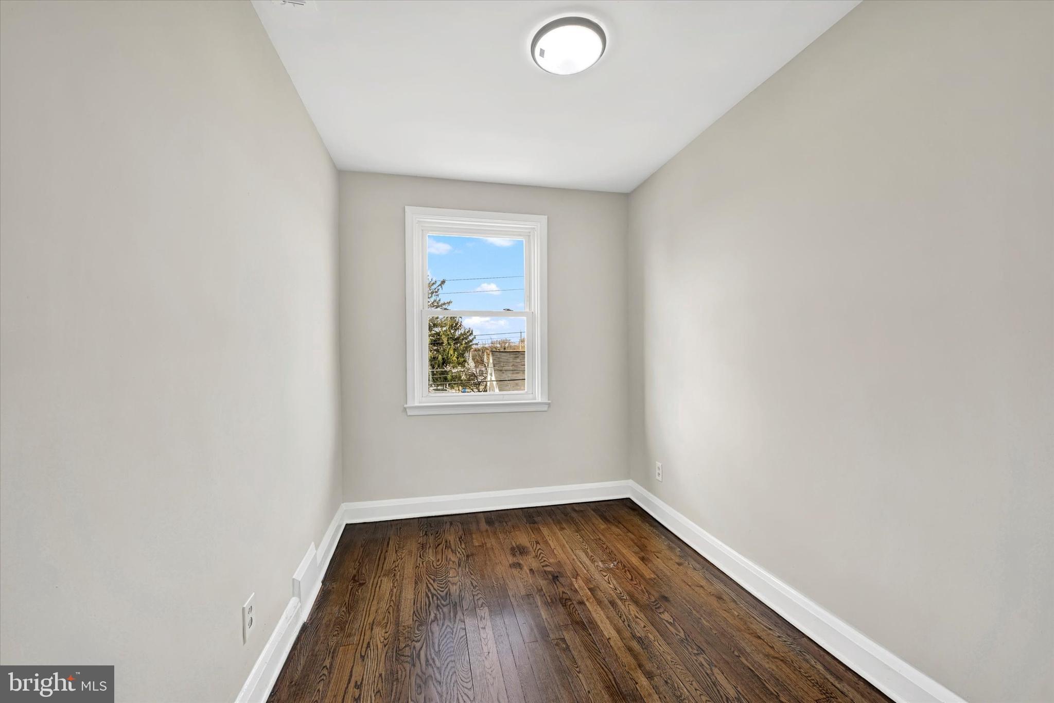 54 Wiltshire Road Essex, MD 21221 - Photo 14 of 22 a view of a room with wooden floor and window