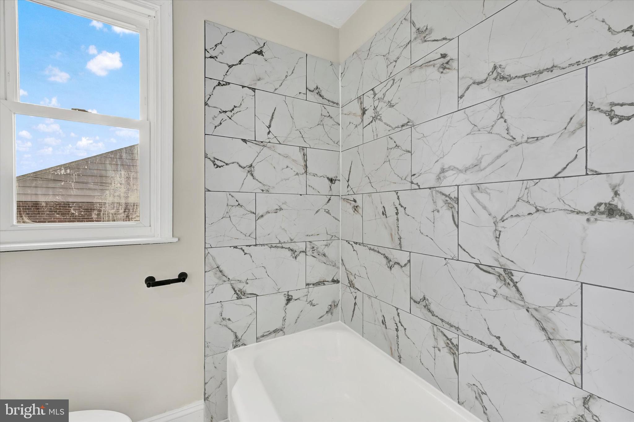 54 Wiltshire Road Essex, MD 21221 - Photo 17 of 22 a bathroom with a bathtub and shower