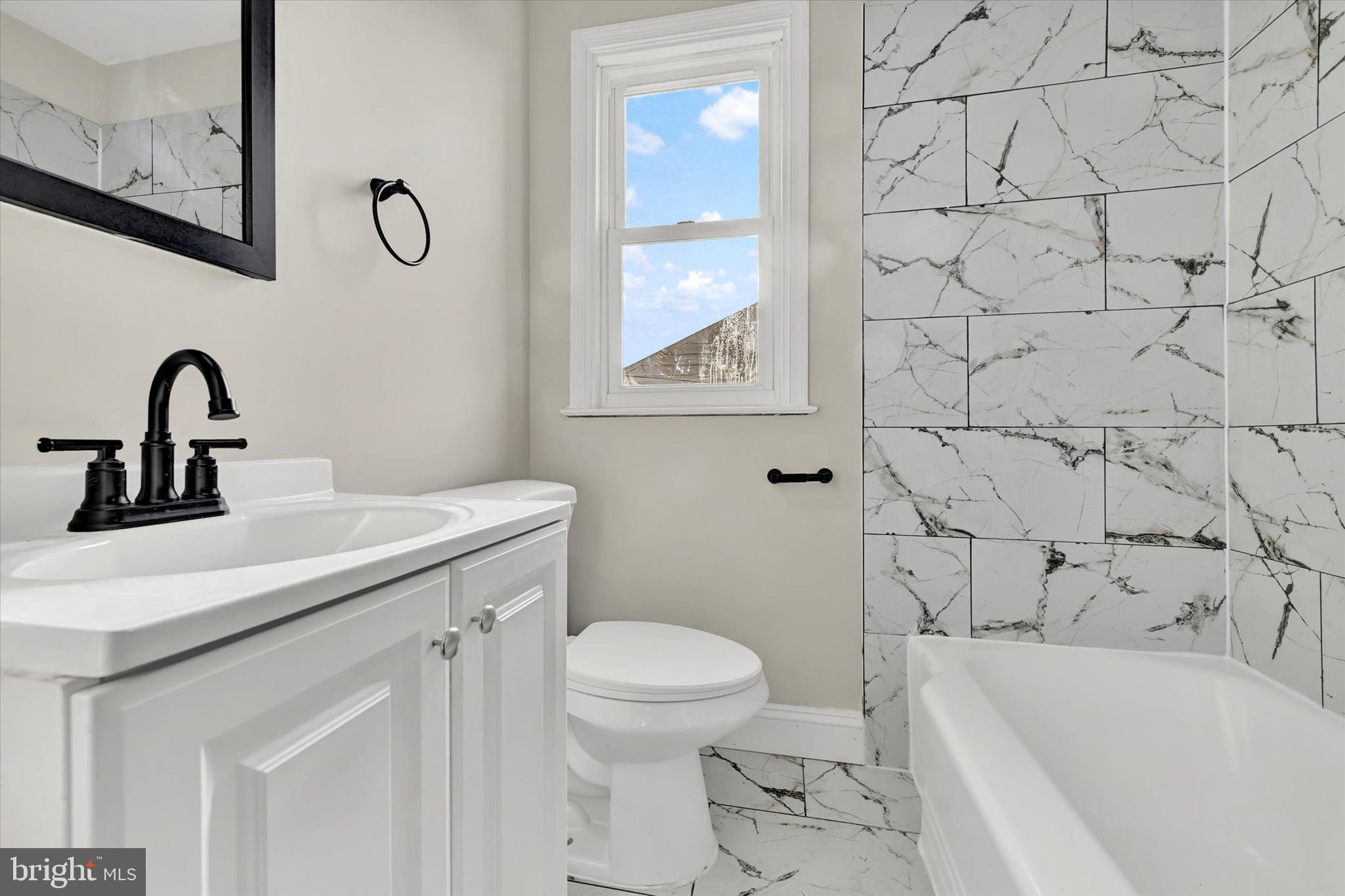 54 Wiltshire Road Essex, MD 21221 - Photo 18 of 22 a bathroom with a sink a toilet and a bathtub