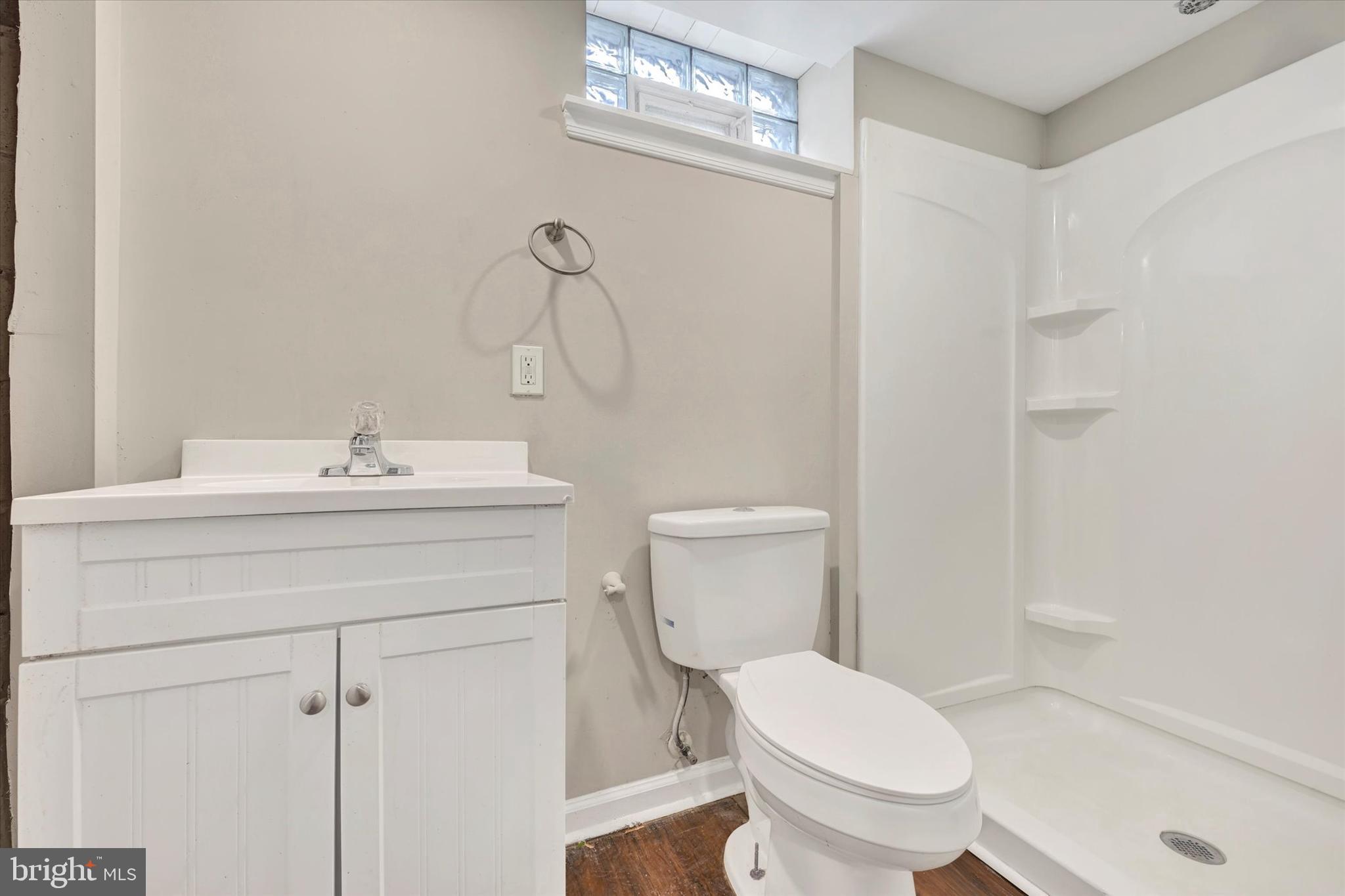 54 Wiltshire Road Essex, MD 21221 - Photo 21 of 22 a bathroom with a toilet sink vanity and mirror