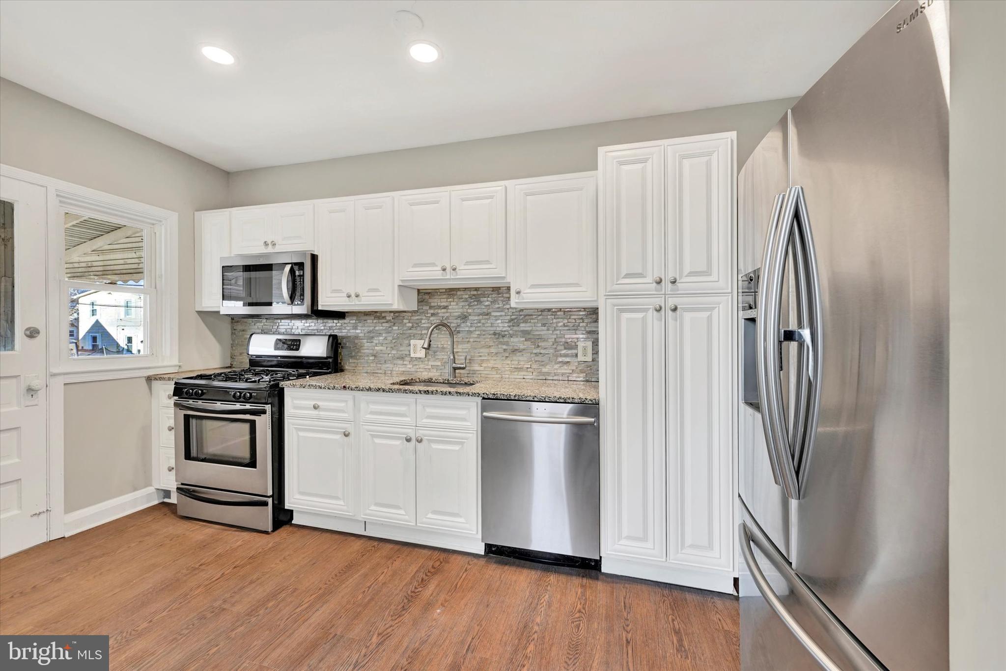 54 Wiltshire Road Essex, MD 21221 - Photo 8 of 22 a kitchen with stainless steel appliances a refrigerator sink and microwave
