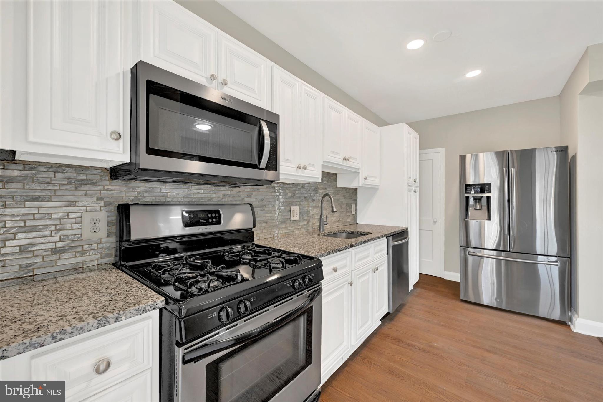 54 Wiltshire Road Essex, MD 21221 - Photo 9 of 22 a kitchen with a stove and a microwave