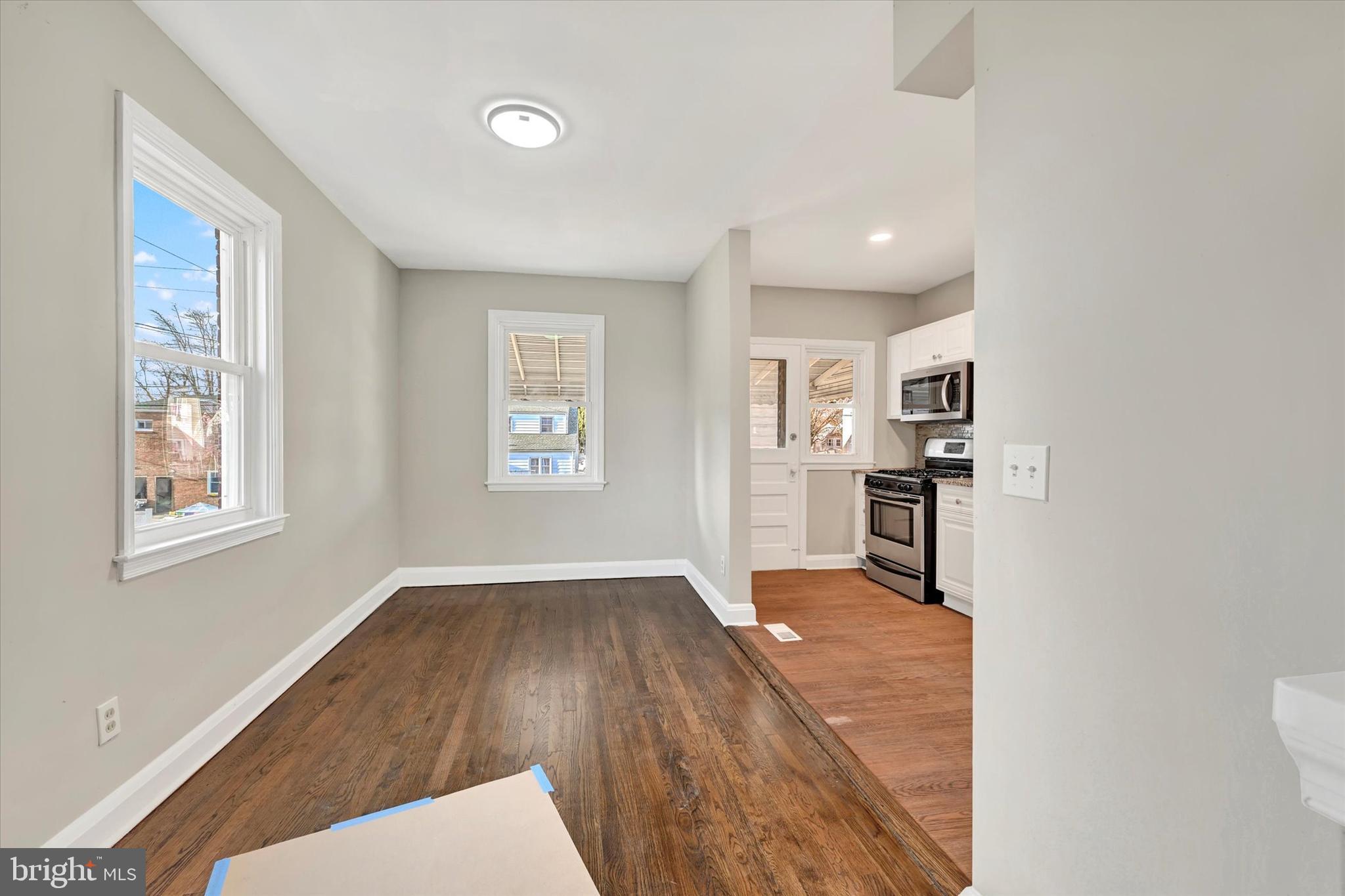 54 Wiltshire Road Essex, MD 21221 - Photo 10 of 22 a hallway with wooden floor and windows