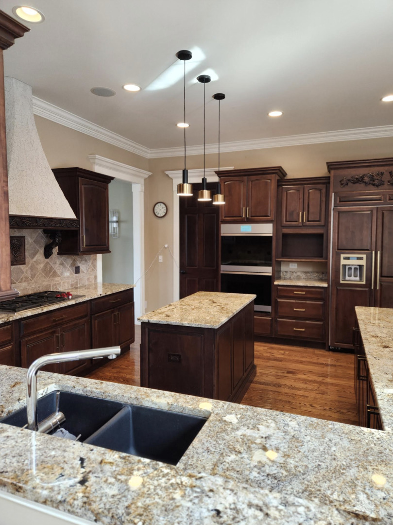 17451 Bridle Trail Road Gurnee, IL 60031 - Photo 22 of 50 a kitchen with kitchen island granite countertop wooden cabinets a refrigerator and a stove