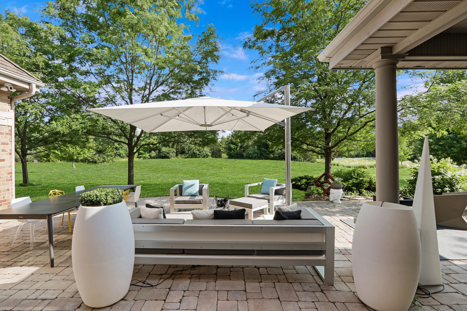 17451 Bridle Trail Road Gurnee, IL 60031 - Photo 7 of 50 a view of a patio with couches potted plants and a big yard