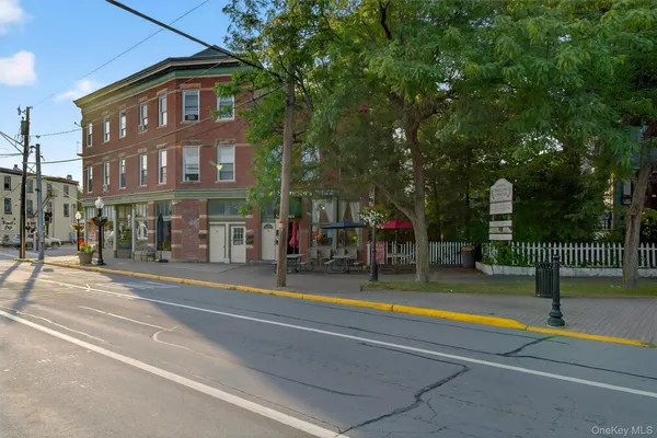 a view of a swimming pool with a small yard and large trees