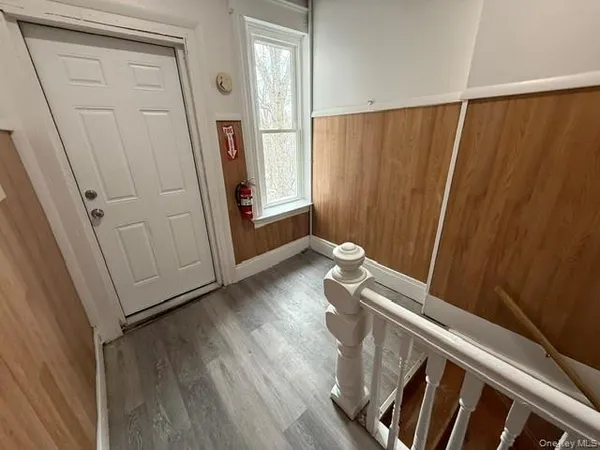 a view of front door with wooden floor