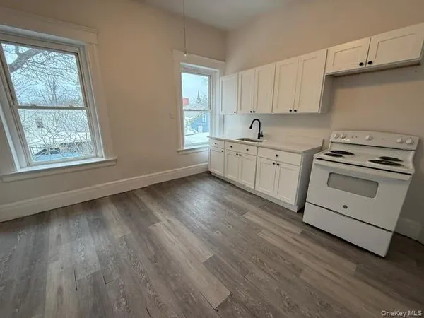 a kitchen with wooden floors and white appliances