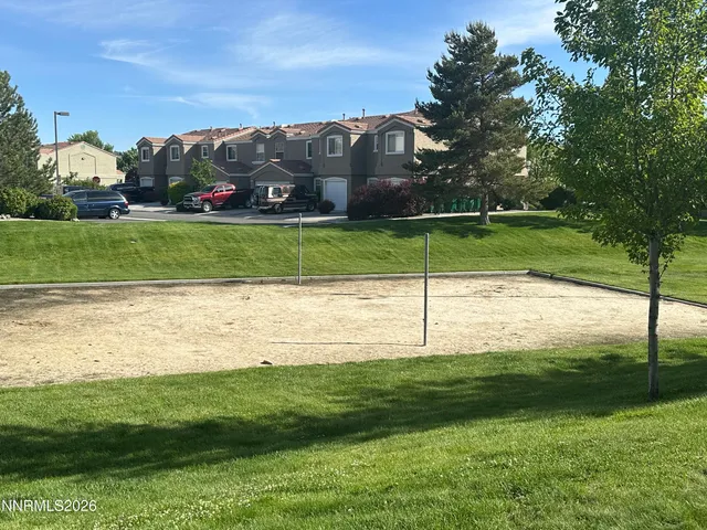 a view of a swimming pool and trees in the background
