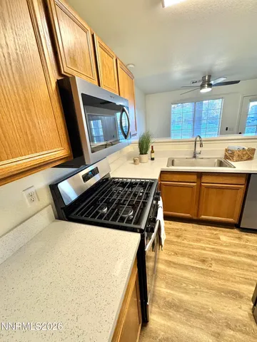 a kitchen with stainless steel appliances granite countertop a sink stove and refrigerator