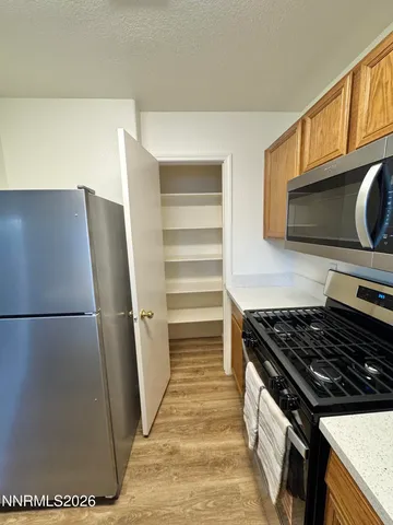 a kitchen with a refrigerator stove and microwave