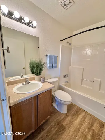 a bathroom with a sink toilet a mirror and shower