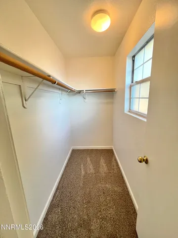 a view of a small space with wooden floor and a window