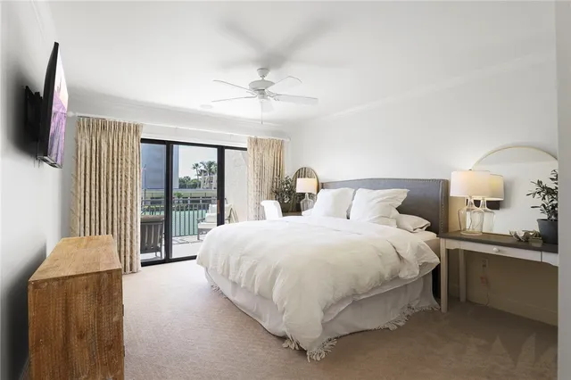 a bedroom with a large bed and a tv