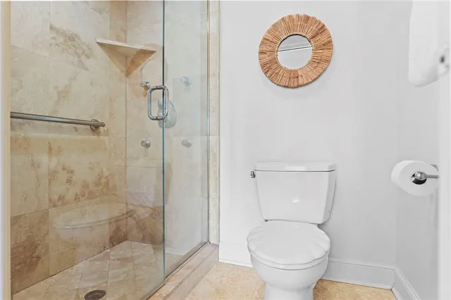 a bathroom with a toilet and a shower