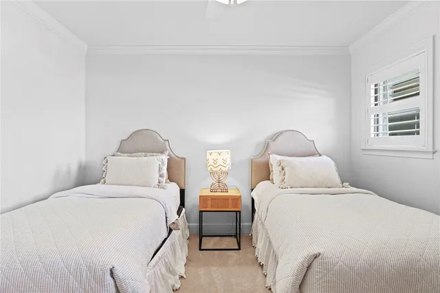 a bedroom with two beds and a night stand