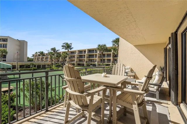 a view of a balcony with two chairs and a table