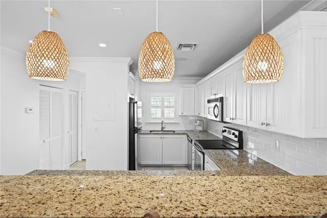 a room with lots of appliances and a table