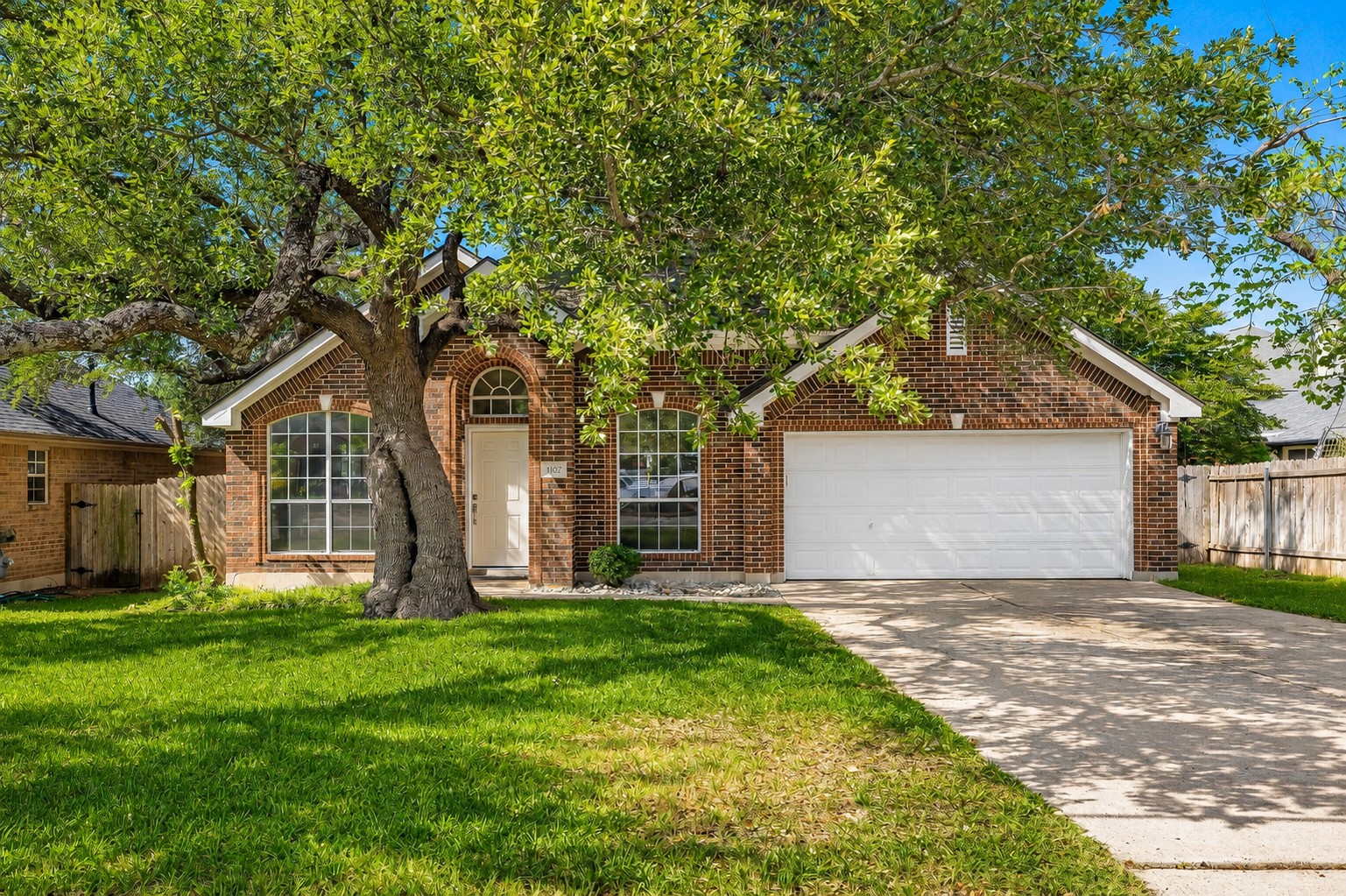 1102 Nelson Ranch Road Cedar Park, TX 78613 - Photo 1 of 37 A classic brick exterior offers enduring appeal with a convenient attached garage and mature shade tree.