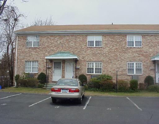 24 Lindstrom Road, Unit 2 Stamford, CT 06902 - Photo 1 of 1 a view of a car parked in front of a brick house
