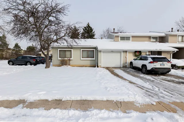 a car parked in front of white house